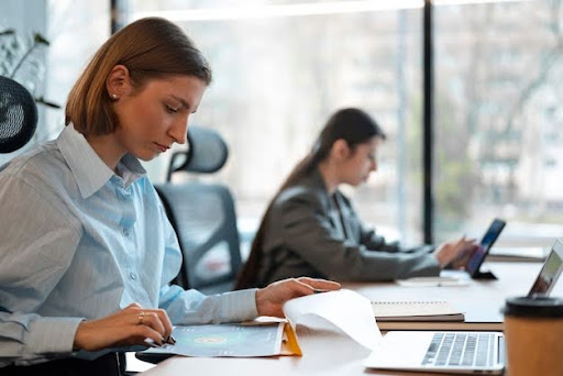 people in the office analyzing and checking finance graphs